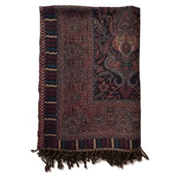 Bombaybirds paisley border throw blanket draped over sofa, showcasing intricate paisley design and soft fabric for living room decor.