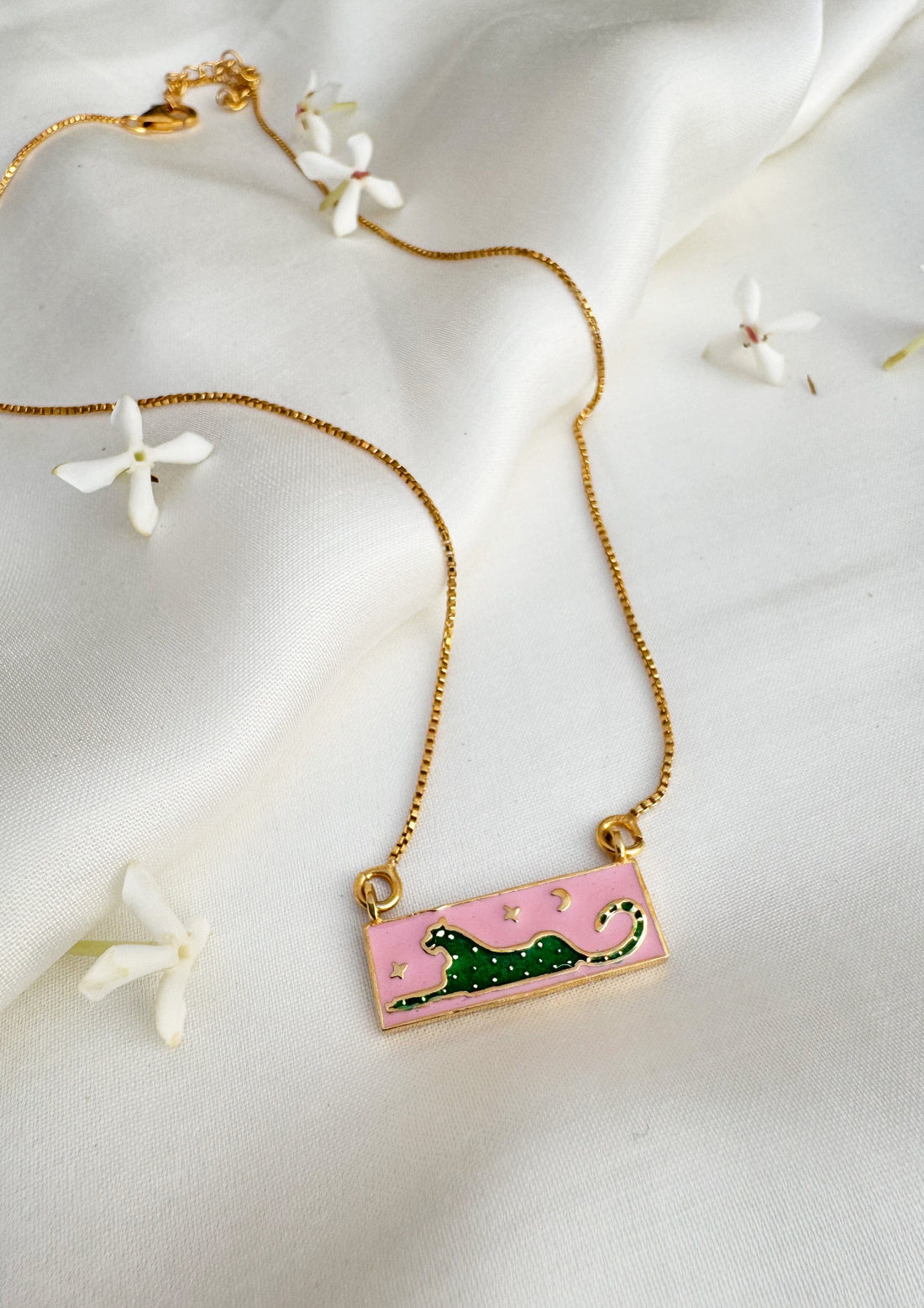 Green leopard meenakari pendant from The Raw India jewelry featuring intricate meenakari design and vibrant green color.