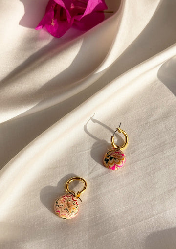 Large gold hoop earrings from The Raw India, stylish jewelry featuring bold hoop design with intricate details.