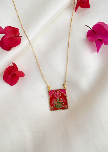 Pink buta meenakari pendant jewelry from The Raw India featuring intricate traditional design and vibrant colors.