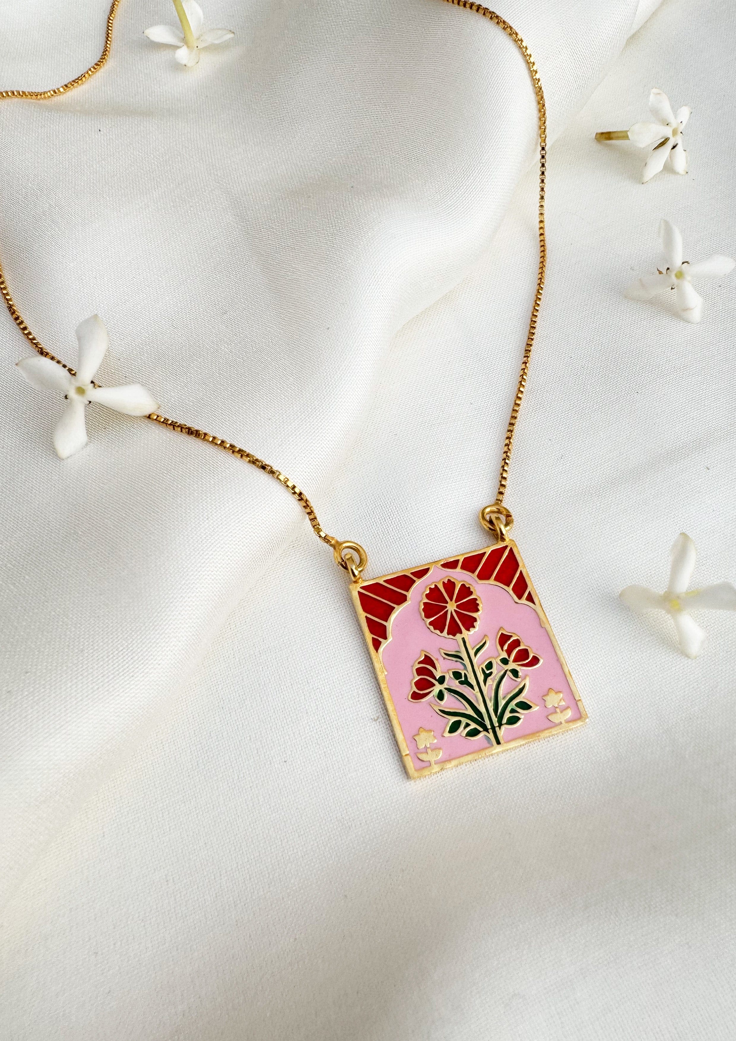 Red Buta meenakari pendant jewelry featuring intricate enamel design, crafted by The Raw India for elegant traditional style.