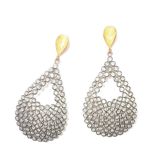 Ofelia earrings by Bombaybirds featuring intricate silver-tone floral design and dangling elements on a neutral background.