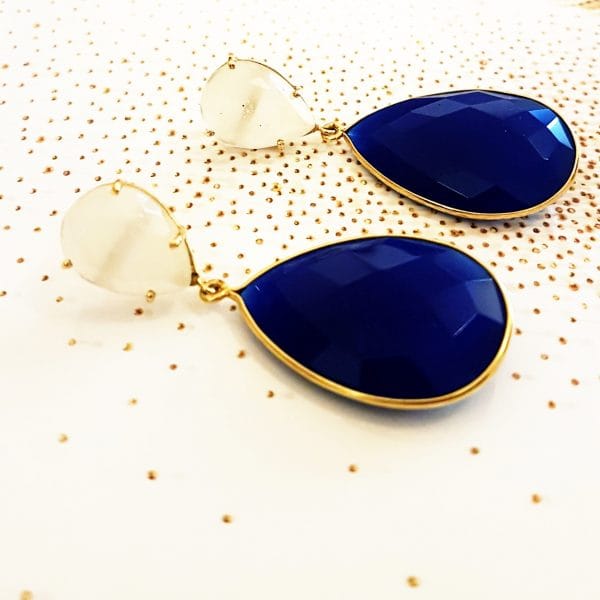 Bombaybirds Nella earrings, silver drop earrings with intricate design, hanging from earlobes, close-up view.