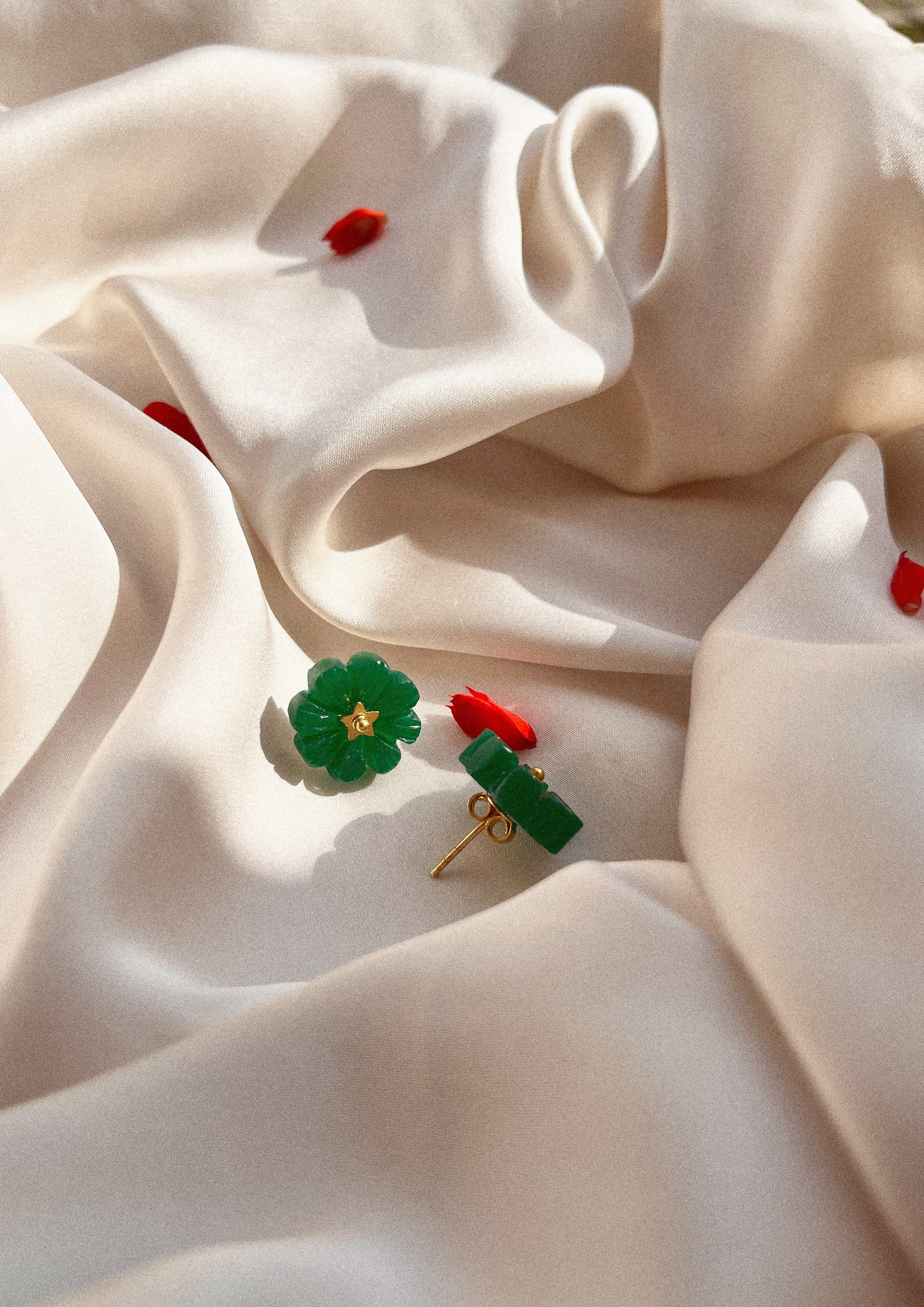 Green onyx flower stud earrings in jewelry from The Raw India featuring delicate floral design and vibrant gemstone details.