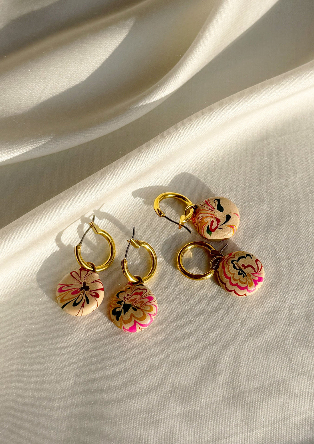 Large gold hoop earrings from The Raw India, stylish jewelry featuring bold hoop design with intricate details.