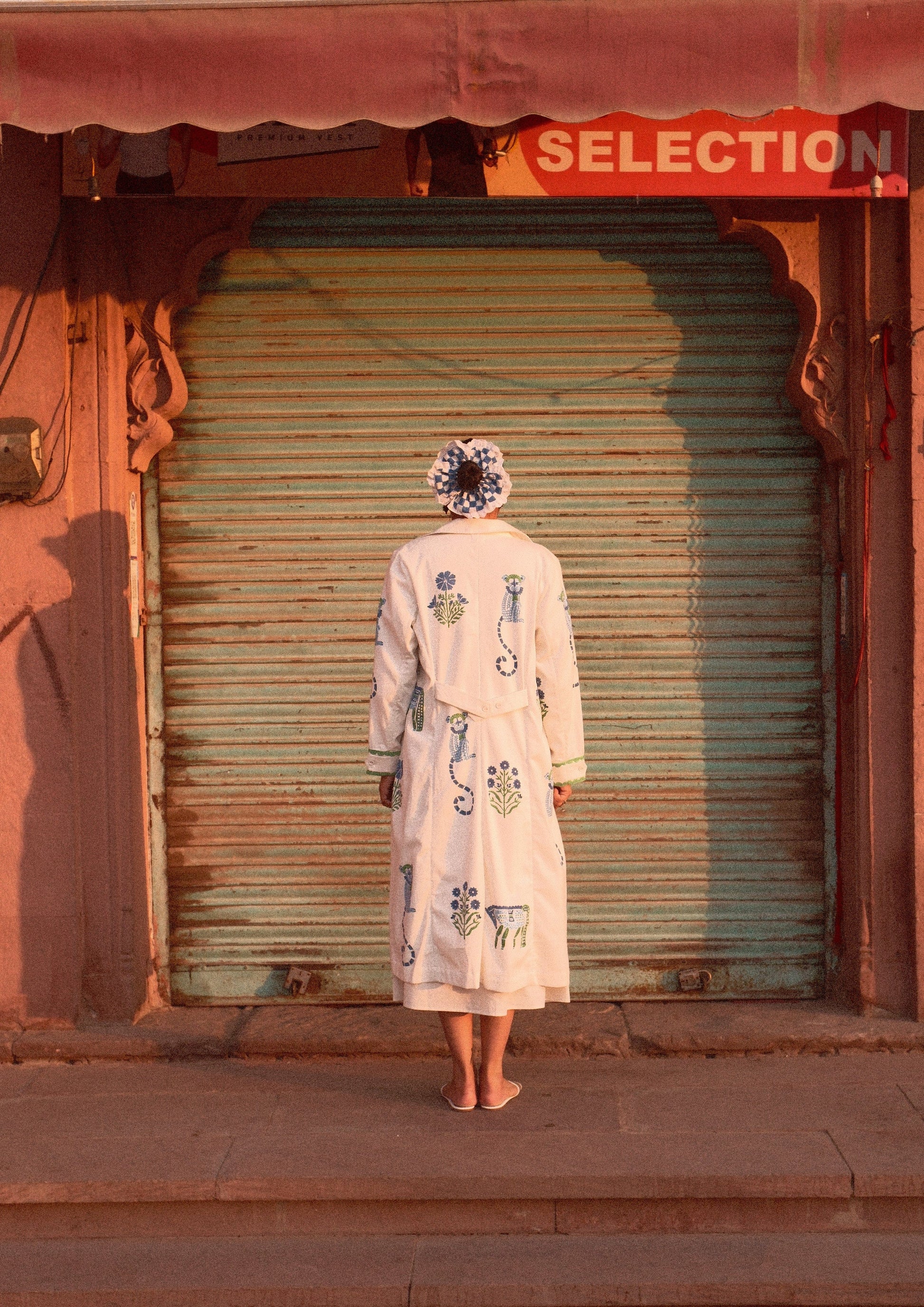 The Raw India Palace coat jodhpur mix print jacket featuring traditional patterns and vibrant colors, displayed on a hanger.