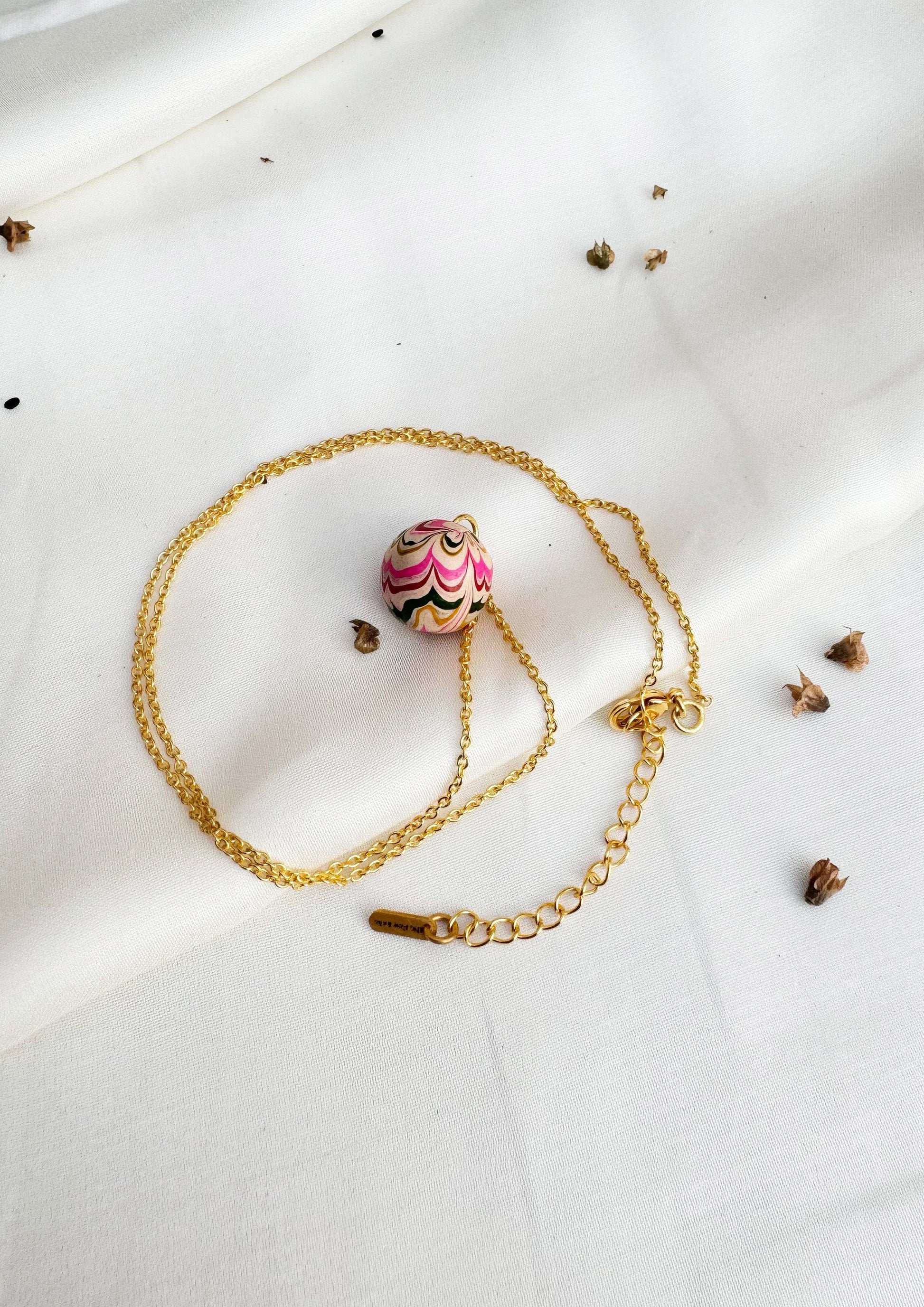 Lac pendant jewelry by The Raw India featuring a handcrafted natural lac design on a silver chain.