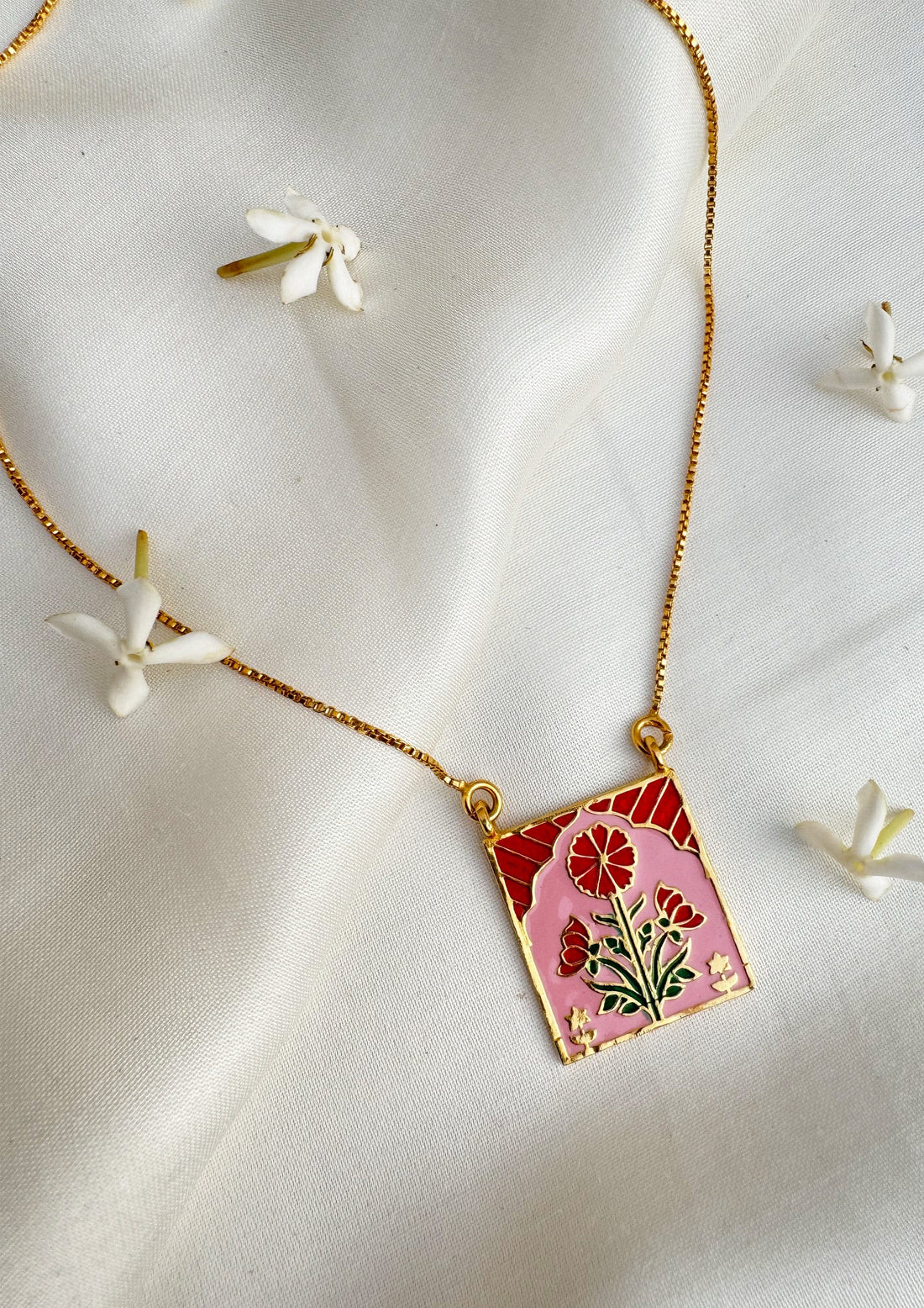 Red Buta meenakari pendant jewelry featuring intricate enamel design, crafted by The Raw India for elegant traditional style.