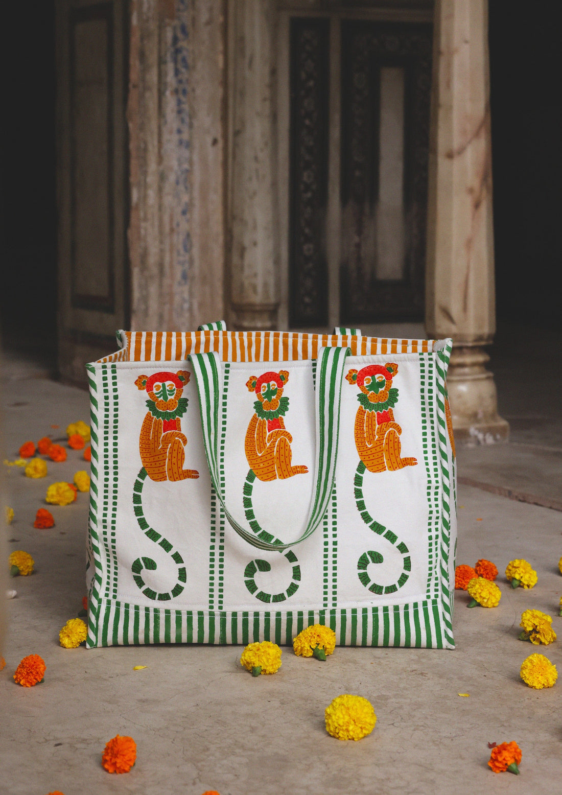 The Raw India tote bag featuring a playful monkey block print, made of eco-friendly fabric with sturdy handles.