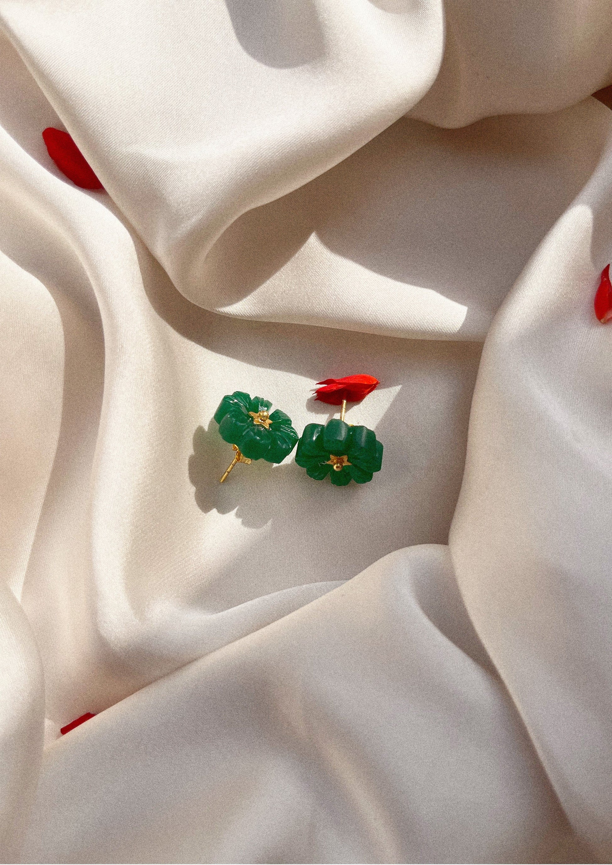Green onyx flower stud earrings from The Raw India jewelry collection, featuring delicate floral design in vibrant green.