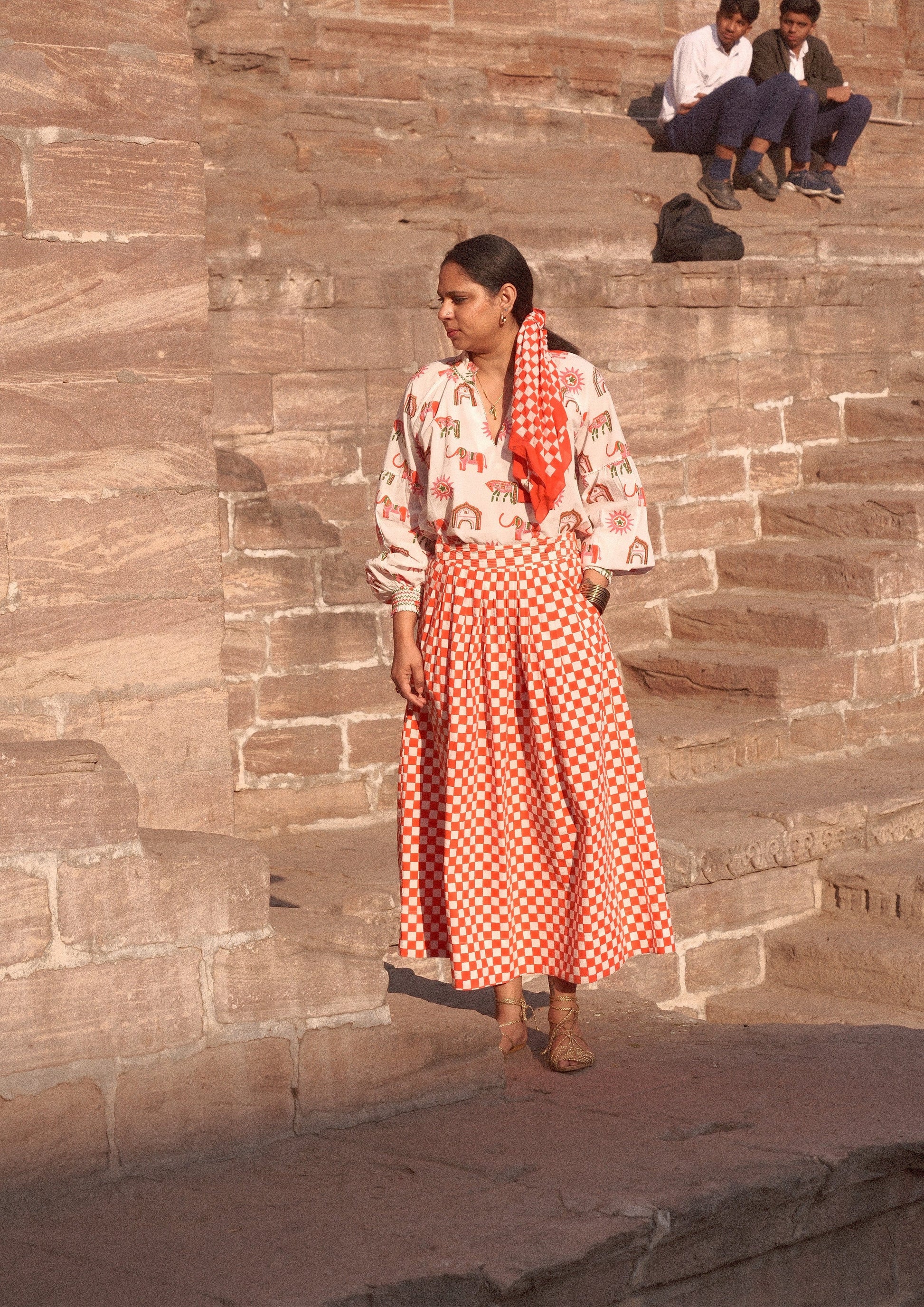 Red check Bawari skirt from The Raw India featuring traditional Indian design and comfortable fabric.