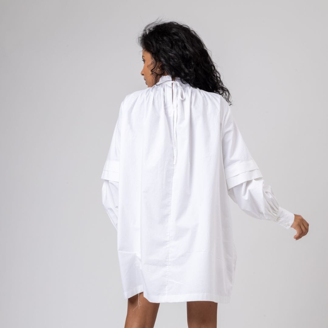 White Alice dress by Doodlage featuring a flowy, lightweight fabric and elegant design, perfect for casual or semi-formal wear.