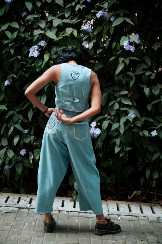 JODI handloom denim pleated trousers showing a relaxed fit with a high waist and wide-leg design.