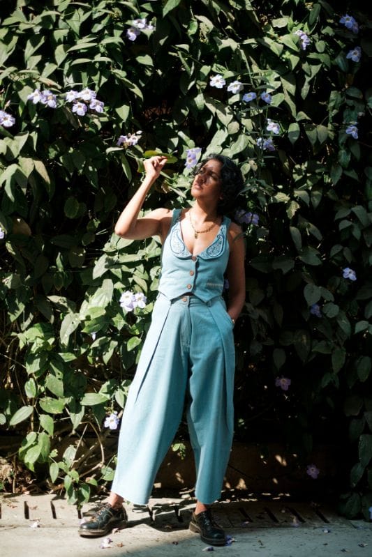 JODI handloom denim pleated trousers with a relaxed fit, showcasing the textured fabric and classic pleats in a natural pose.