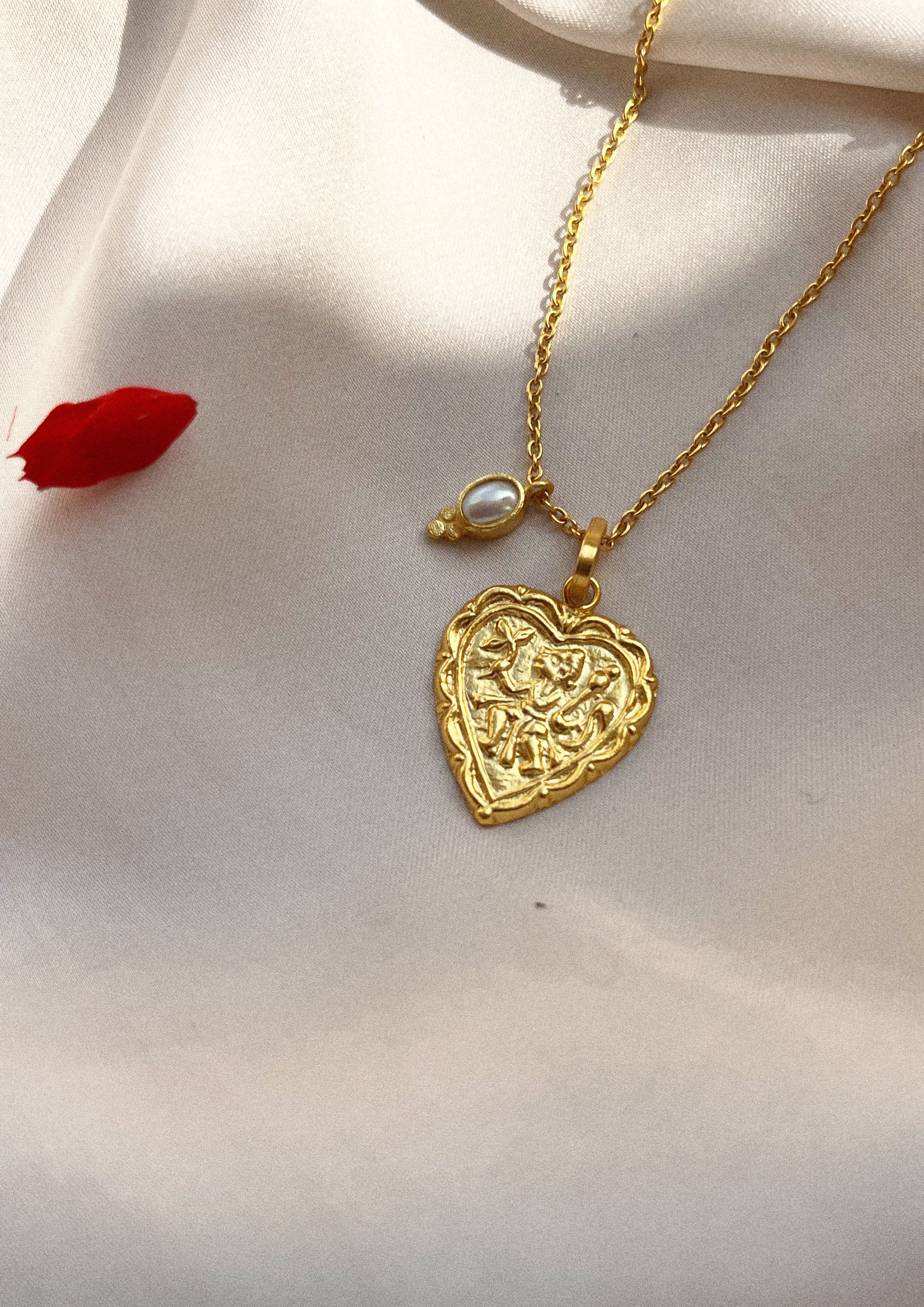 Heart-shaped accessory from The Raw India, featuring intricate details and a polished finish, ideal as a stylish jewelry piece.