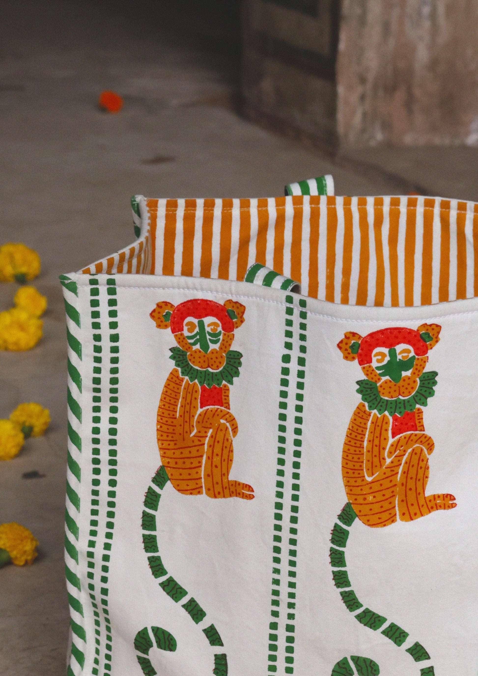 Colorful tote bag with monkey block print from The Raw India, showcasing vibrant fabric and sturdy handles.