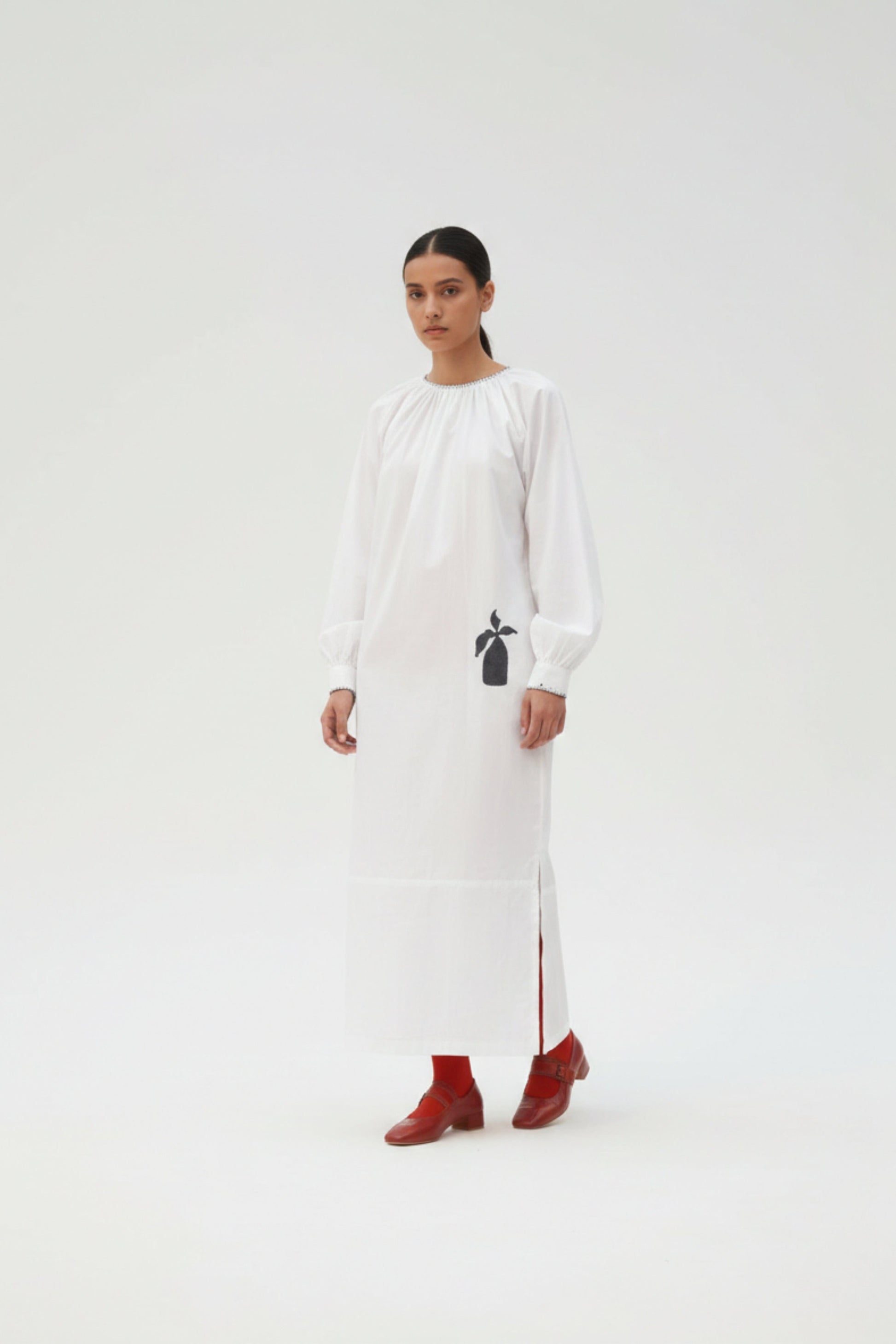White Astrid dress by Doodlage, featuring a flowing fabric and stylish design, displayed on a mannequin.