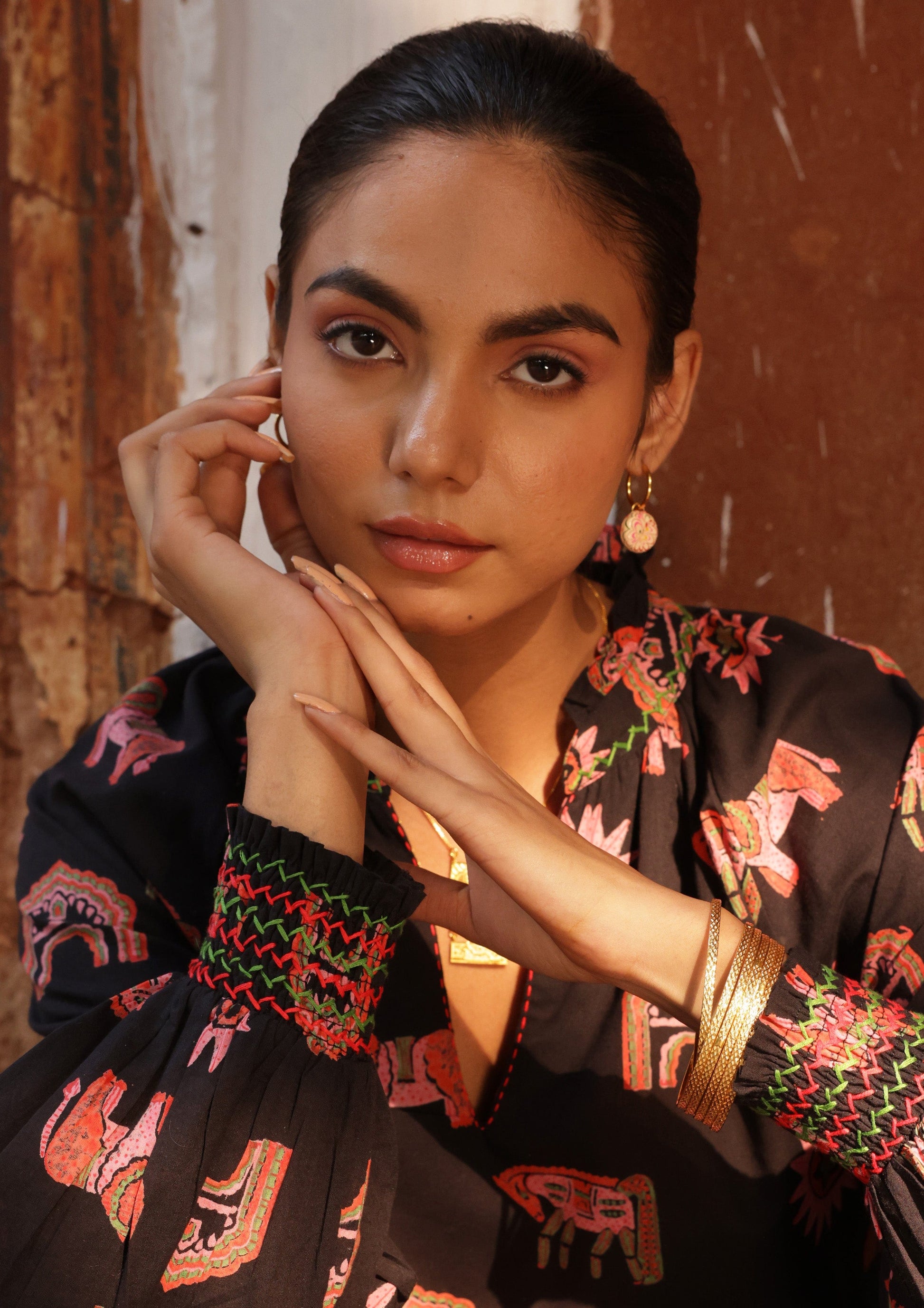 Small hoop earrings by The Raw India, delicate gold jewelry hoops for everyday wear, shown in a close-up image.