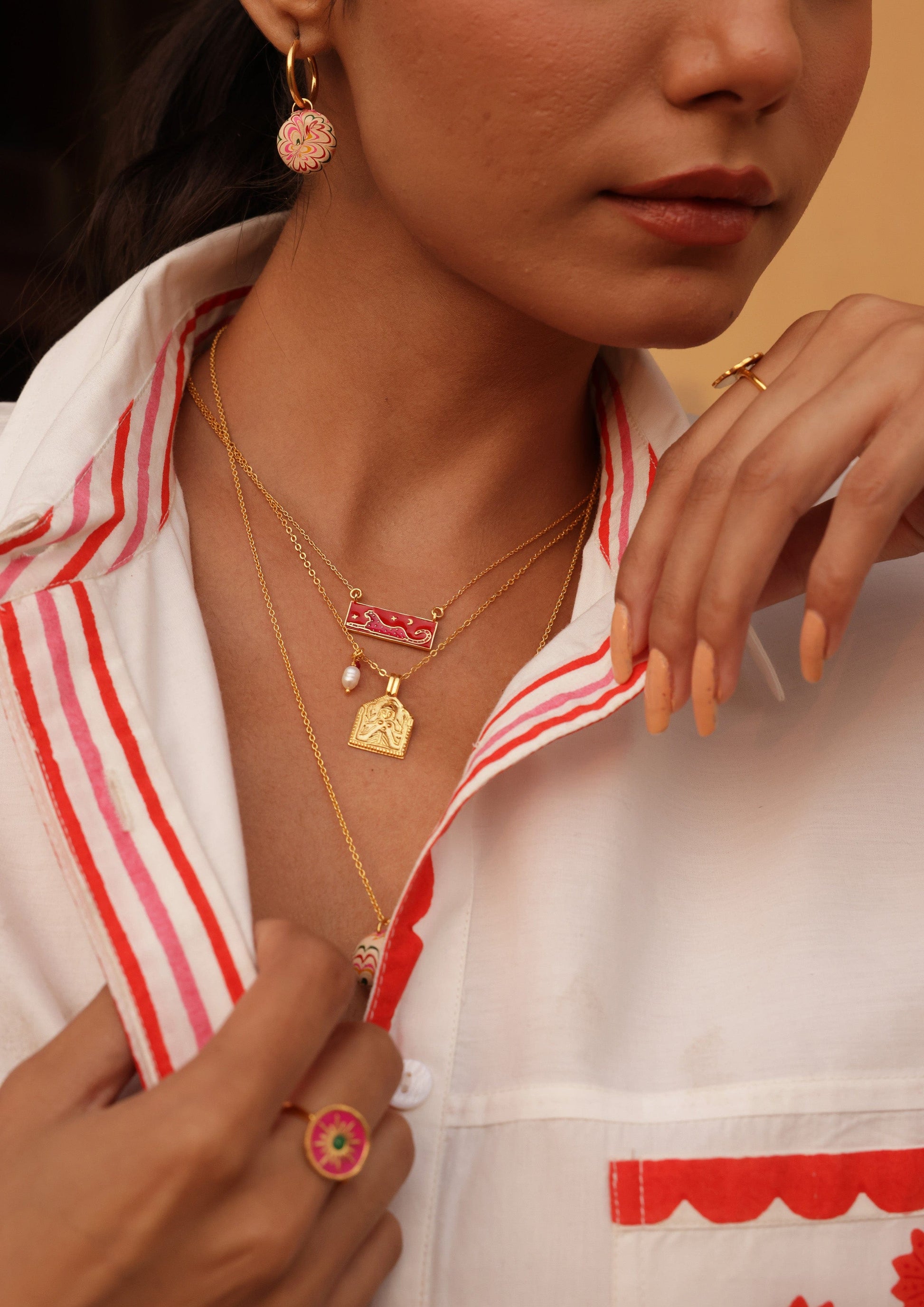 Pink leopard meenakari pendant jewelry with intricate design, showcasing vibrant colors and traditional craftsmanship.