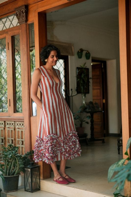 JODI Doriya dress displayed on a hanger, featuring intricate embroidery and colorful fabric perfect for traditional or festive occasions.