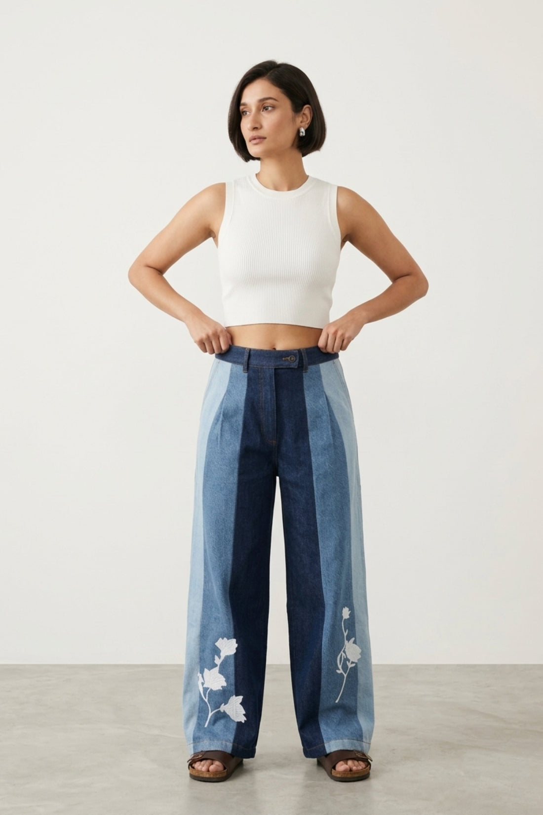 Doodlage Ember denim panelled pants showing a relaxed fit with patchwork and distressed detailing in blue denim fabric.