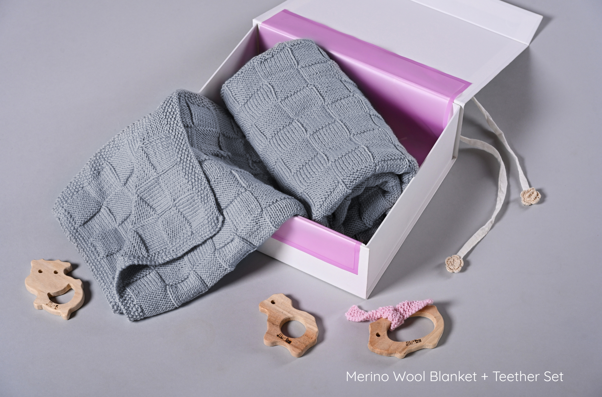 Gray Merino wool blanket by Masaya Home, soft and cozy throw with a smooth texture, perfect for layering on the bed or sofa.