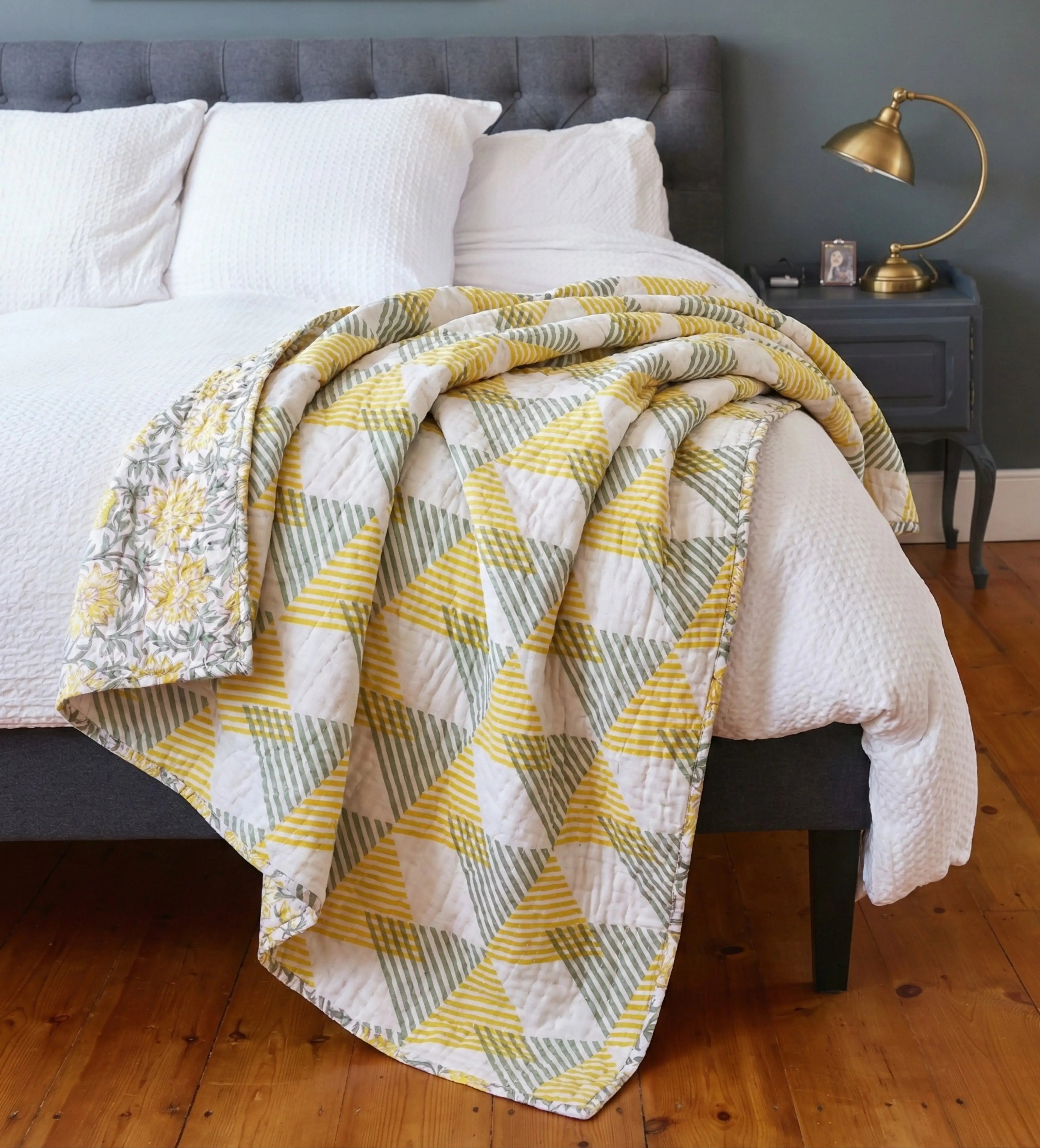 Reversible Sunnie chintz quilt by Bombaybirds, showcasing floral pattern on soft fabric for living room decor.
