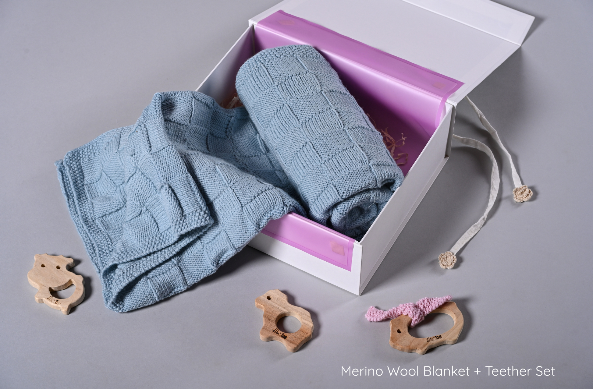 Blue Merino wool blanket by Masaya Home, soft and cozy with a textured knit pattern, perfect for adding warmth to a living space.