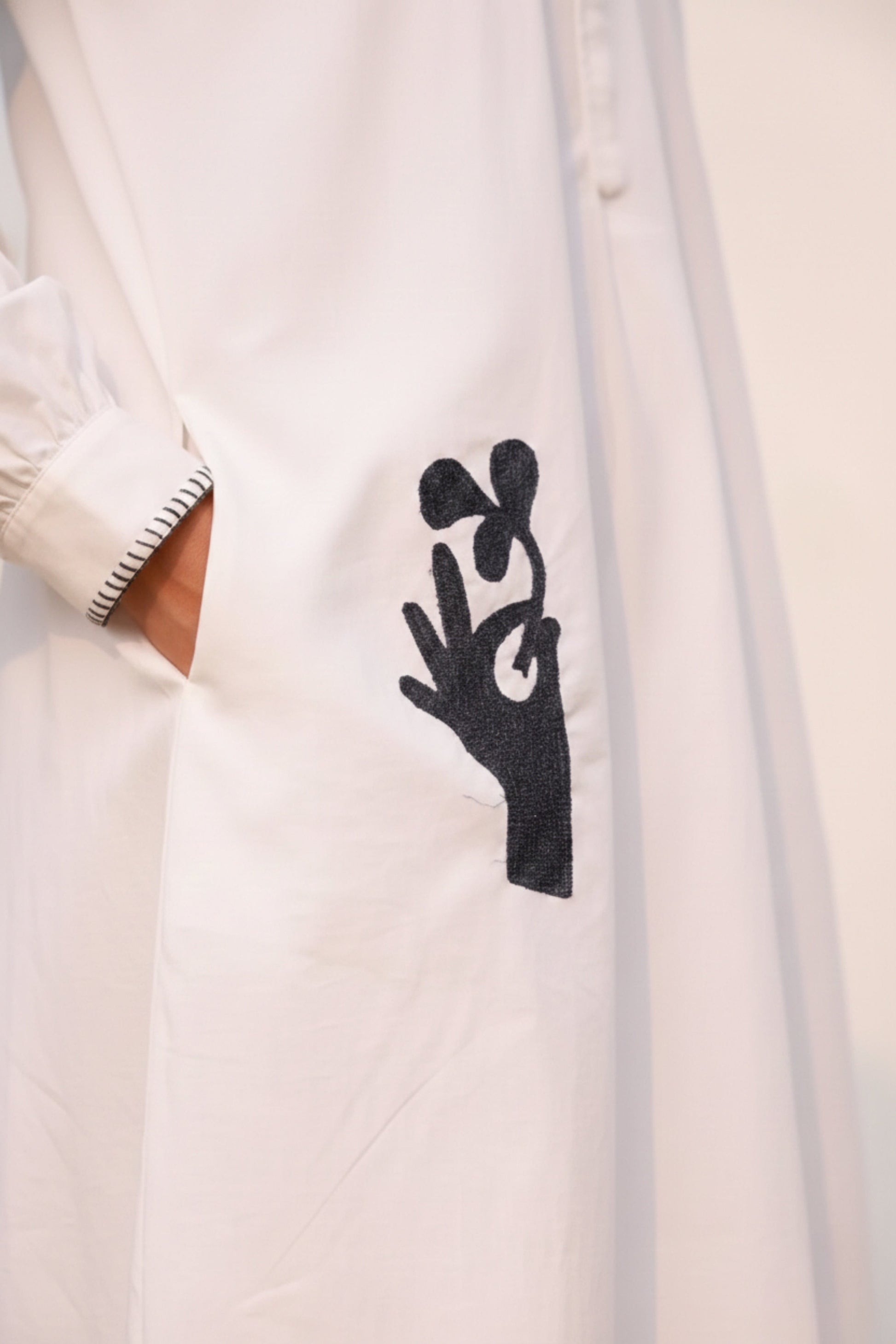 White Astrid dress by Doodlage featuring a flowy, lightweight fabric and elegant design perfect for casual or semi-formal wear.