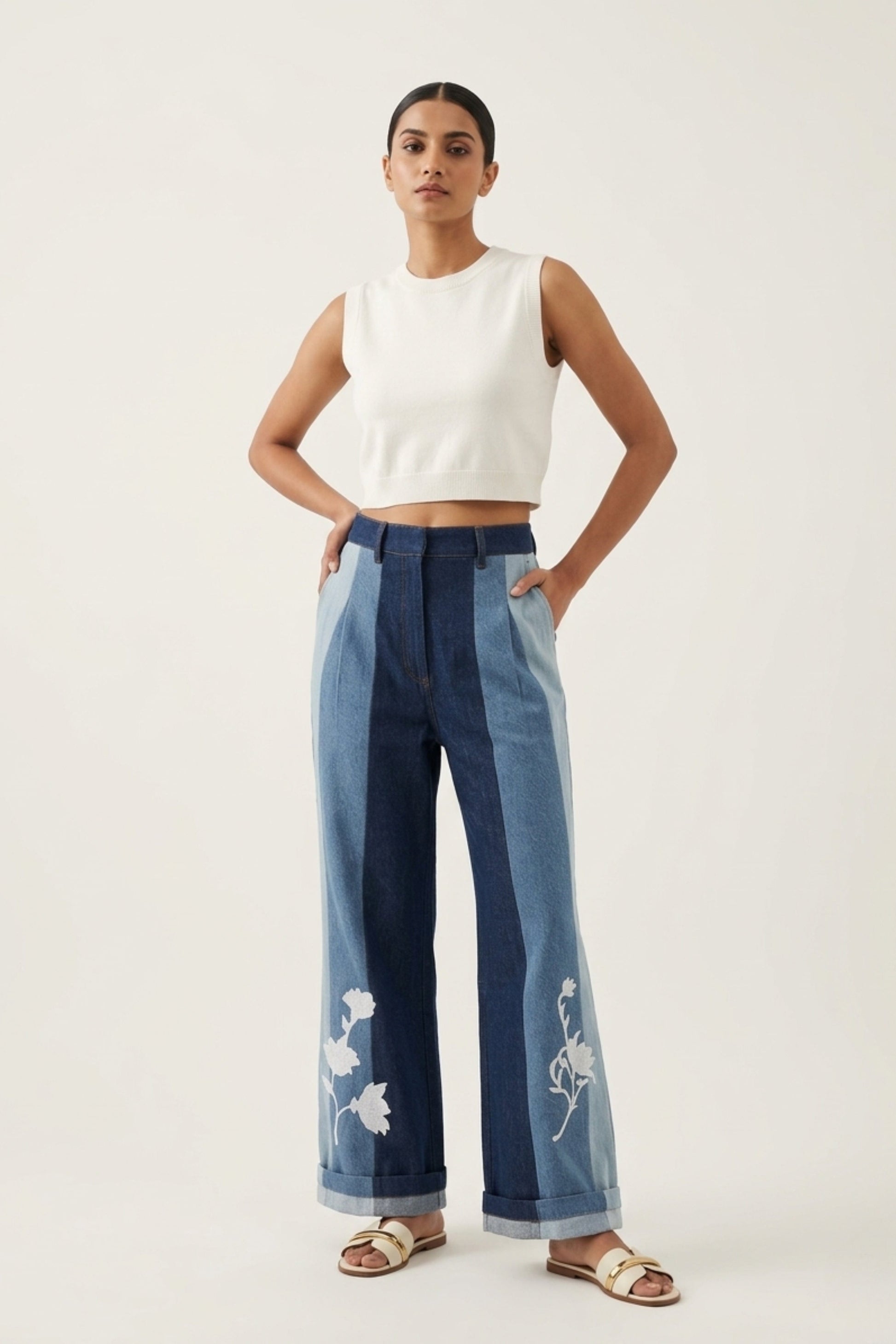 Doodlage Ember denim panelled pants featuring a relaxed fit with patchwork details and tapered legs.