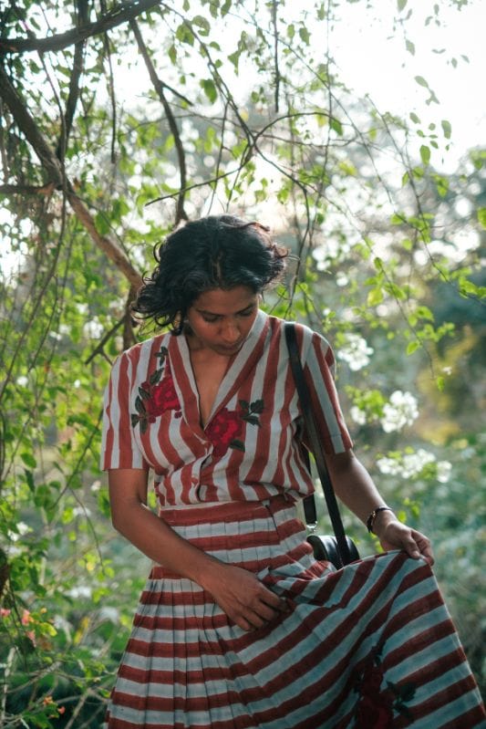 JODI Doriya blouse, stylish shirt with intricate embroidery and lightweight fabric, displayed on a hanger.