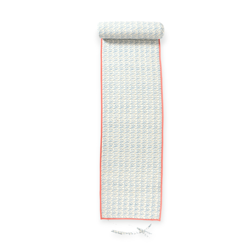 Apricot-colored Bombaybirds beach mat laid out on sandy shore, showcasing its lightweight, portable design for outdoor relaxation.