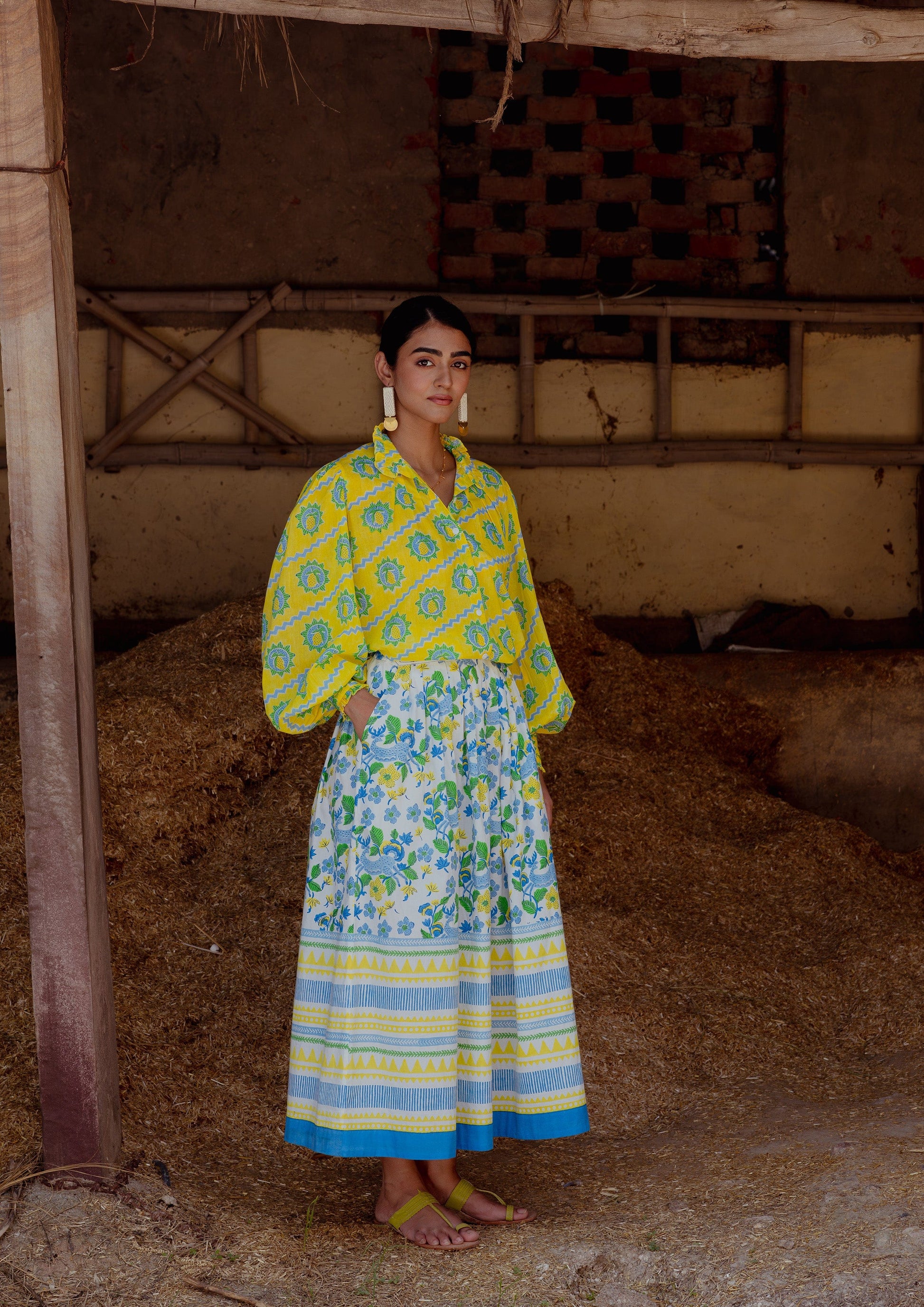 The Raw India Bawari Skirt in swamp deer print, featuring traditional design and flowing fabric, worn as stylish bottoms.