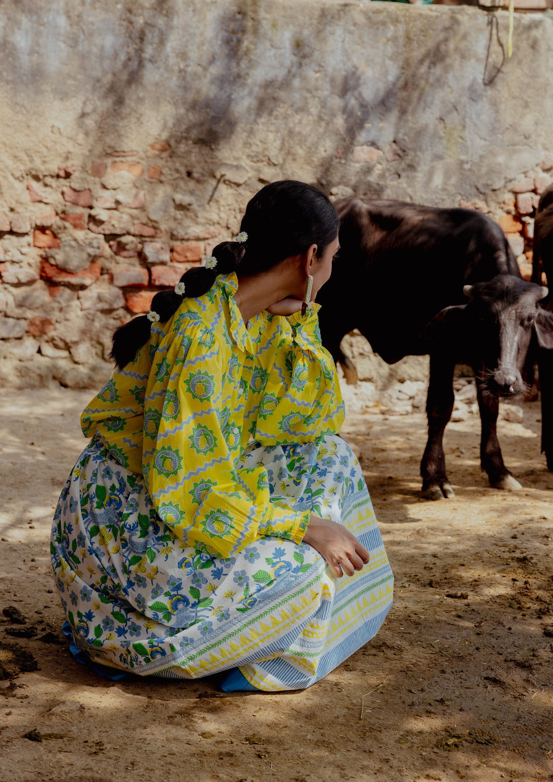 The Raw India Bawari Skirt in swamp deer print, featuring traditional design and flowing fabric, worn as stylish bottoms.