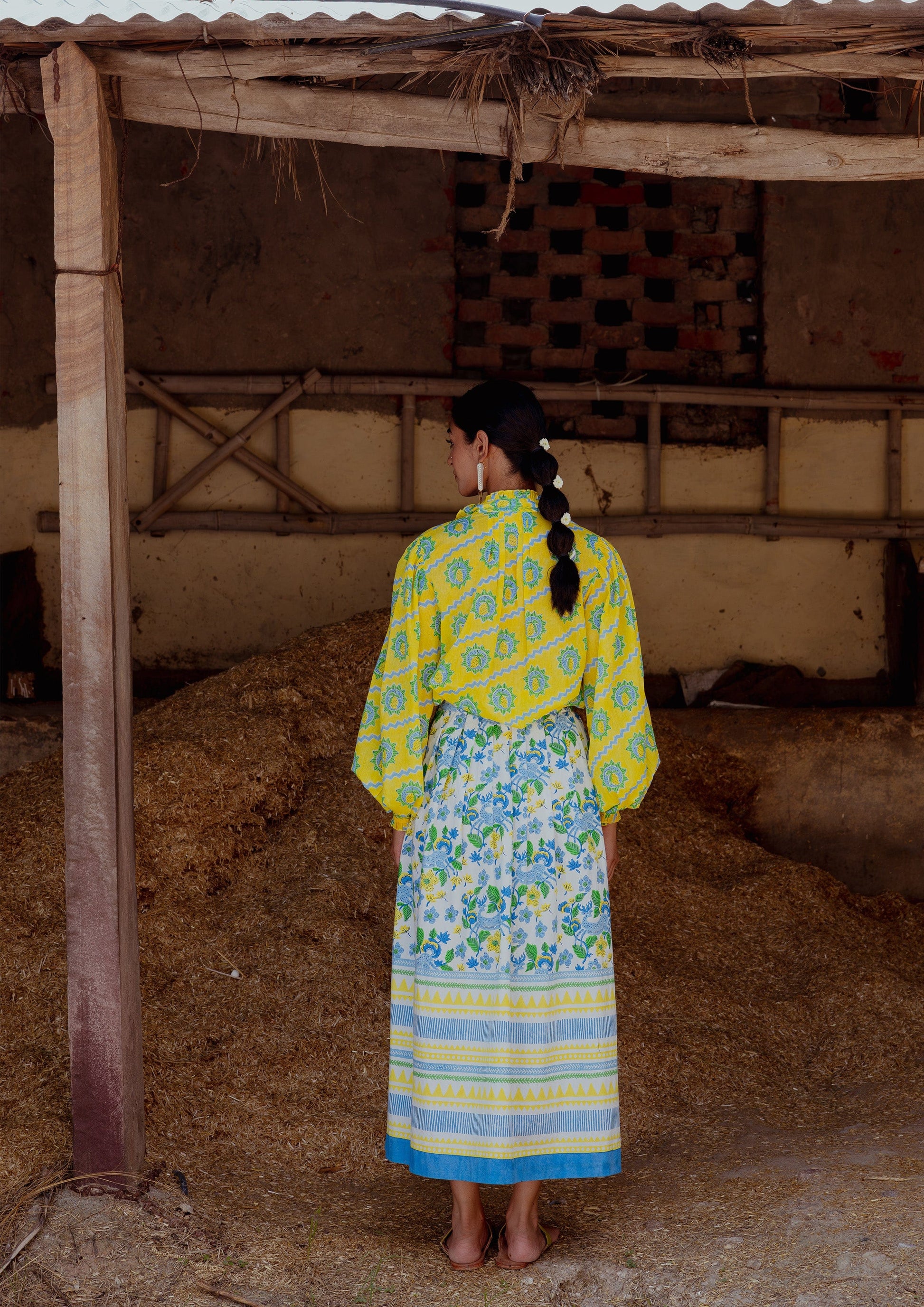 The Raw India Bawari Skirt Swamp Deer in earthy tones, featuring traditional embroidery and relaxed fit, styled on a model.