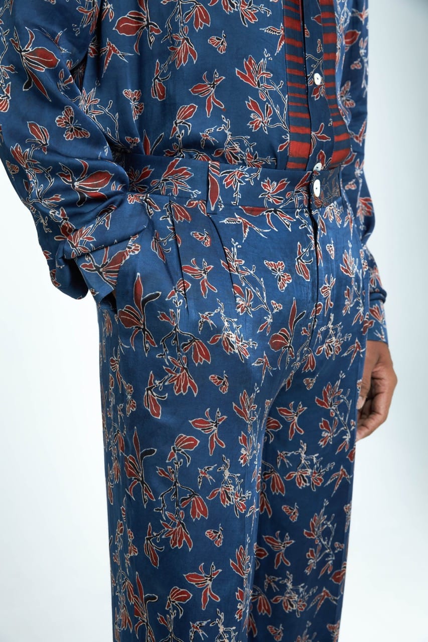 Anushe Pirani garden pleat pants featuring wide-leg design, high waist, and pleated details, shown in a natural fabric with a relaxed fit.