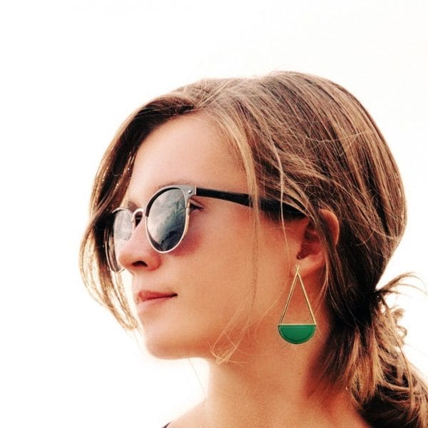 Bhumi gold earrings by Bombaybirds featuring intricate design with green gemstone accents, displayed on a white background.
