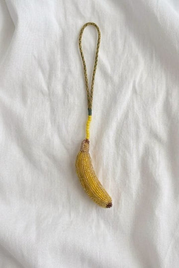 JODI banana beaded charm accessory with colorful beads, ideal for decorating bags or jewelry, on a plain background.