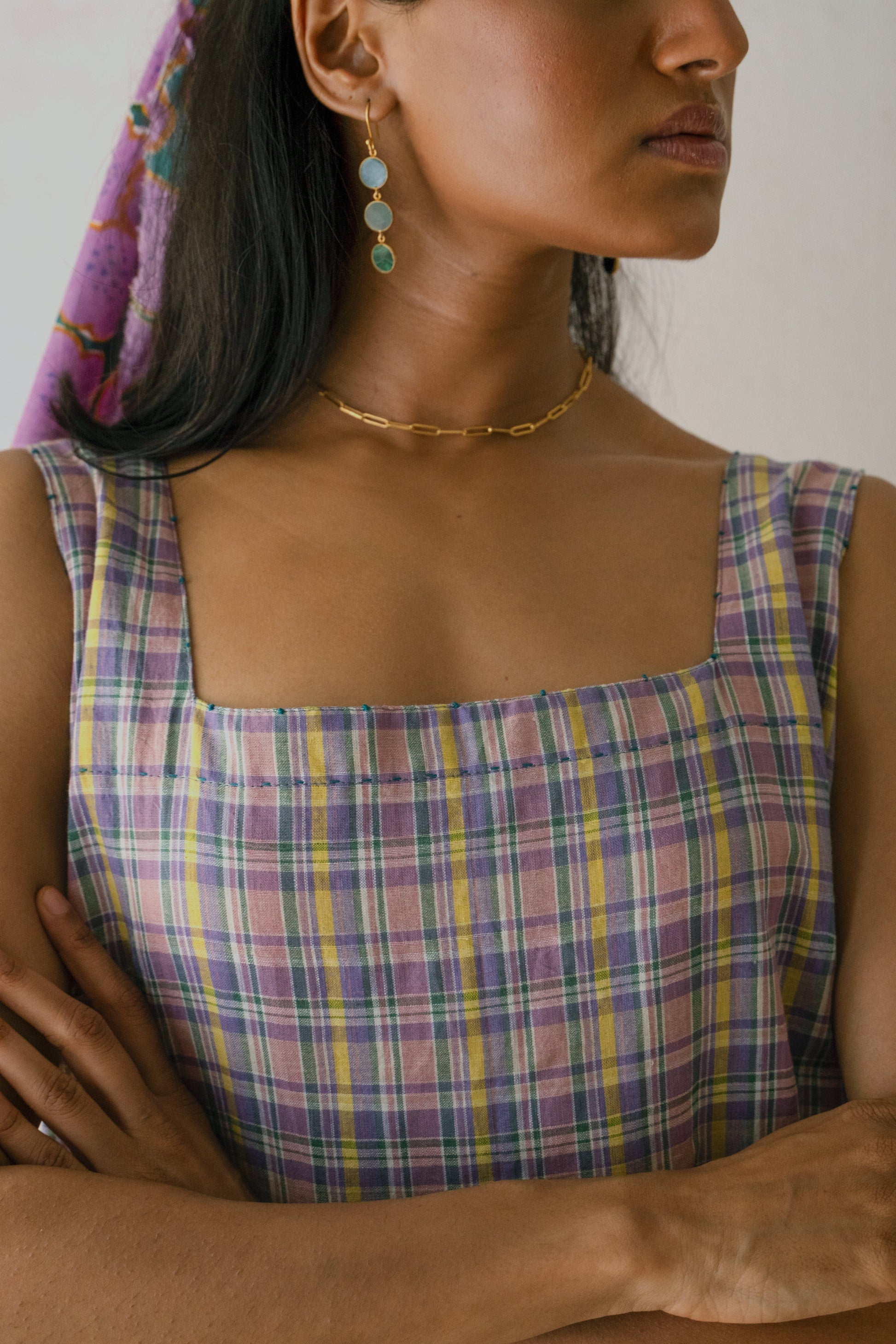 Deeta Meadow dress shown on a hanger, featuring a flowy fabric with floral patterns and a fitted bodice.