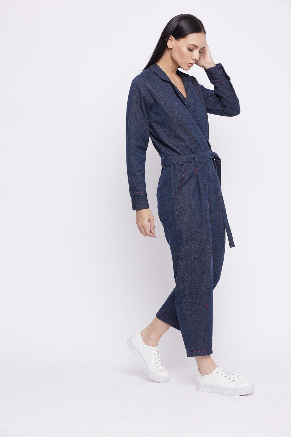 Upcycled denim jumpsuit by Doodlage featuring a relaxed fit, front pockets, and adjustable straps on a model.