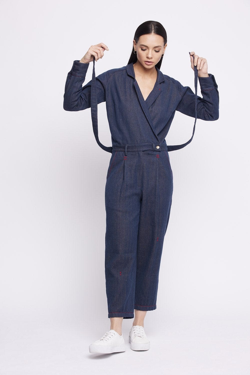 Upcycled denim jumpsuit by Doodlage, featuring a fitted design with long sleeves and patchwork details.