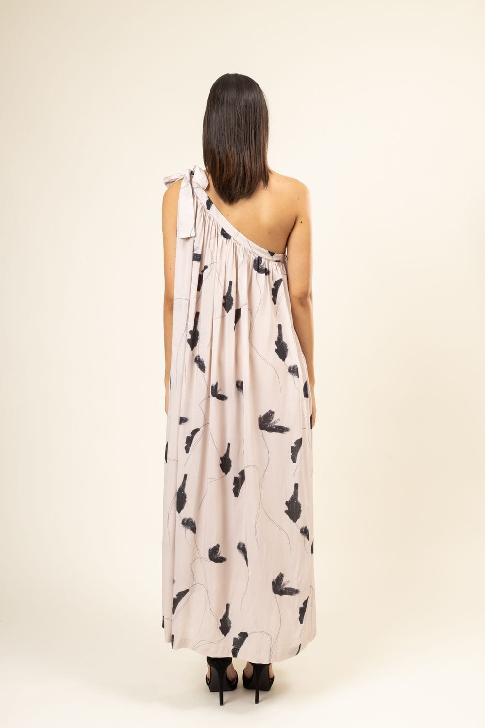 Daryl printed dress by Doodlage, featuring vibrant patterns and a flowy silhouette, shown on a model.