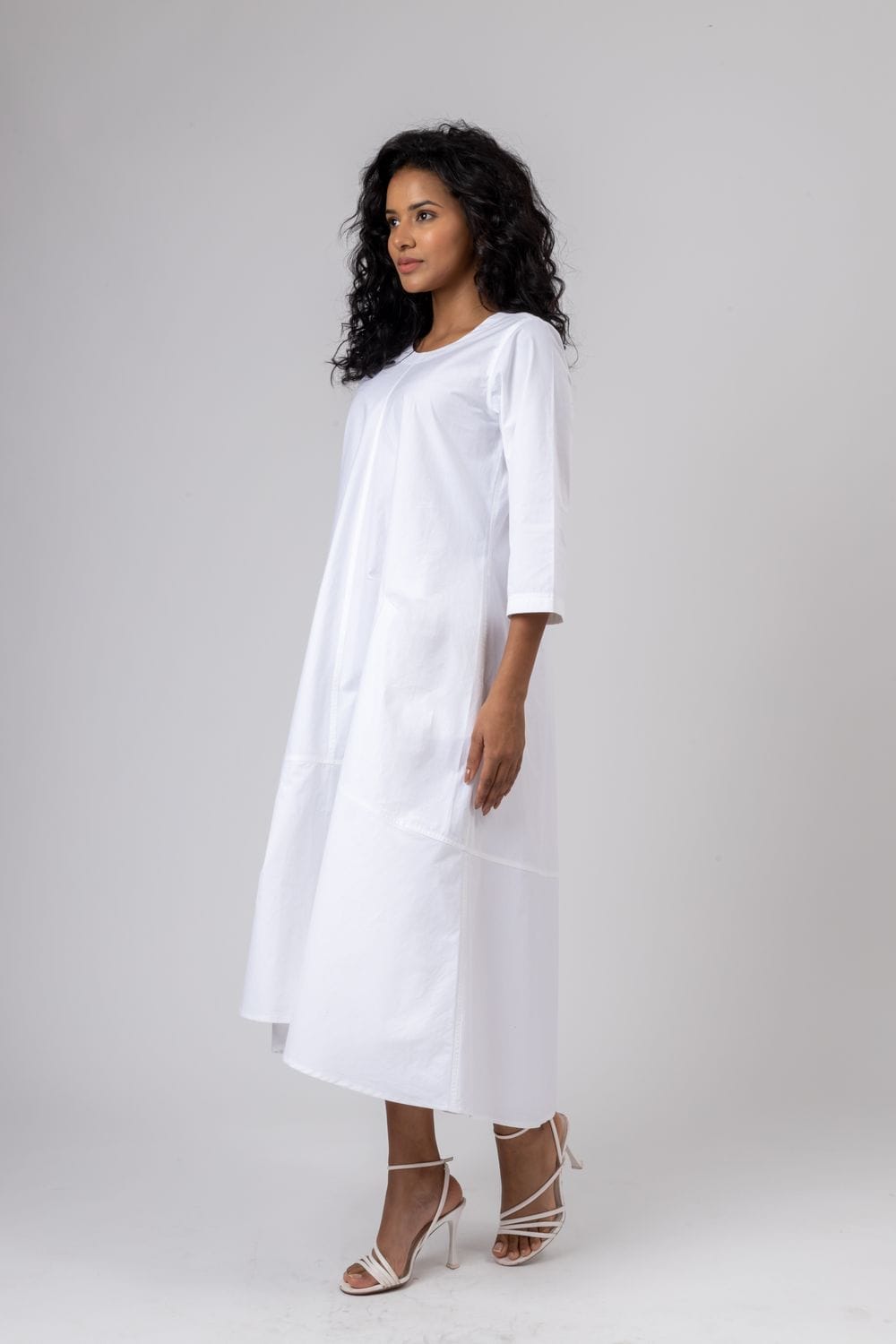 Doodlage Jill white dress displayed on a hanger, featuring a simple, elegant design with short sleeves and a flowy silhouette.