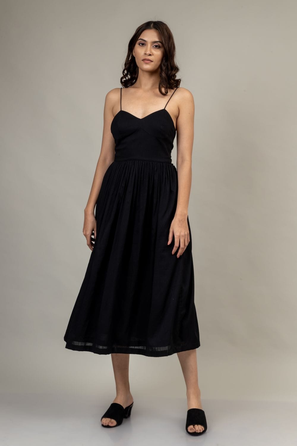 Doodlage Mary black dress with elegant fit and subtle detailing, shown on a hanger against a neutral background.