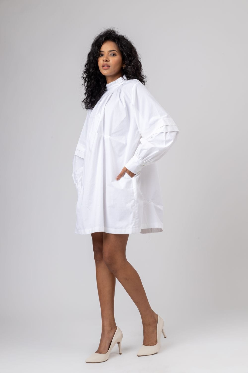 White Alice dress by Doodlage, featuring a lightweight fabric and stylish design, shown on a hanger.