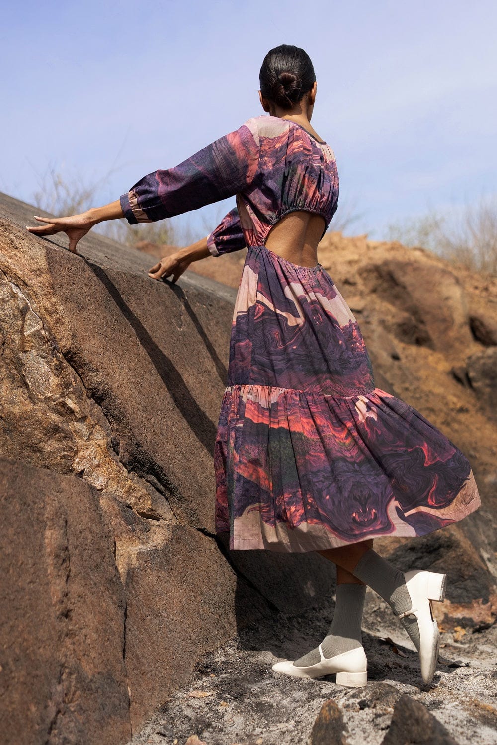 Amino printed Doodlage dress with colorful geometric patterns, long sleeves, and a relaxed fit, displayed on a hanger.