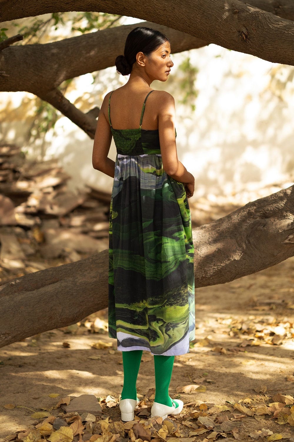 Doodlage Ella green dress with floral print and flowy design, displayed on a hanger against a neutral background.