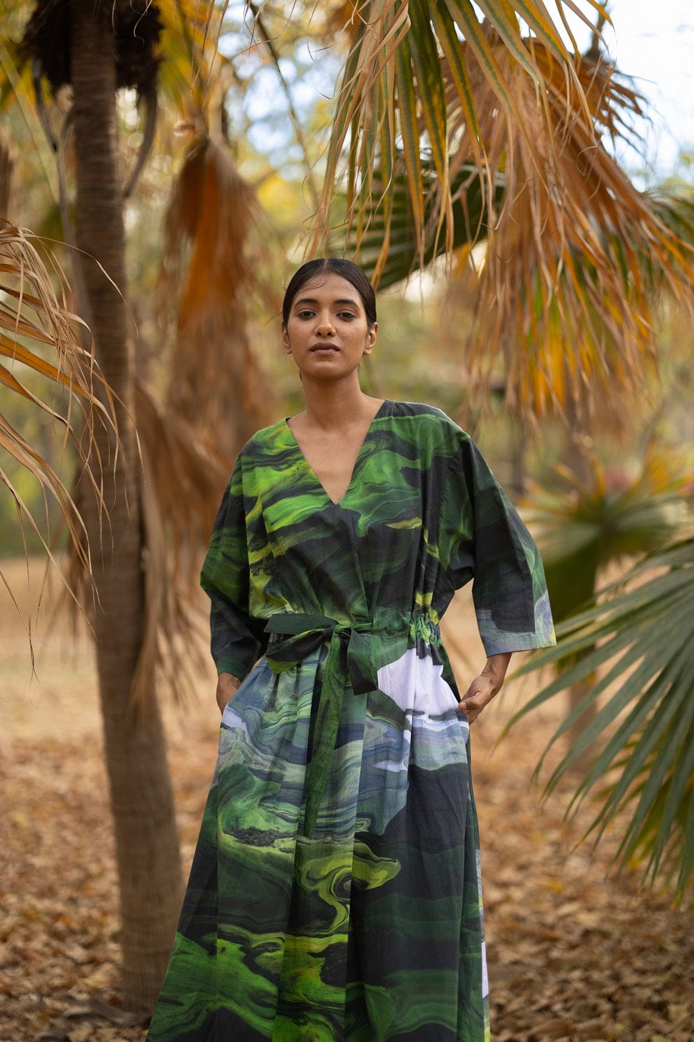 Doodlage Doris green dress with long sleeves and a relaxed fit, displayed on a hanger against a neutral background.