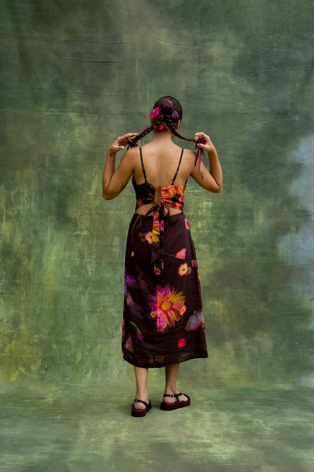 Doodlage Lucie printed dress displayed on a hanger with vibrant floral patterns and lightweight fabric details.