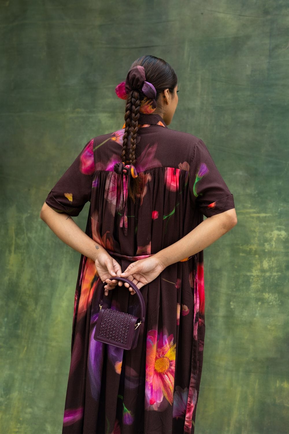 Doodlage Zora brown dress with flowing fabric and stylish design, displayed on a hanger against a neutral background.